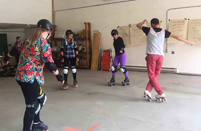 Instructor and students roller skating.