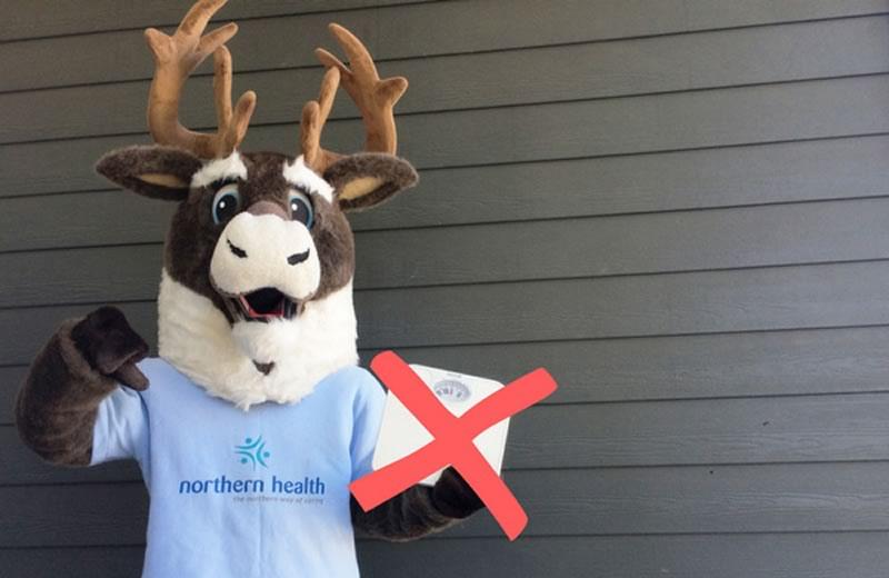 Spirit the caribou mascot holding scale