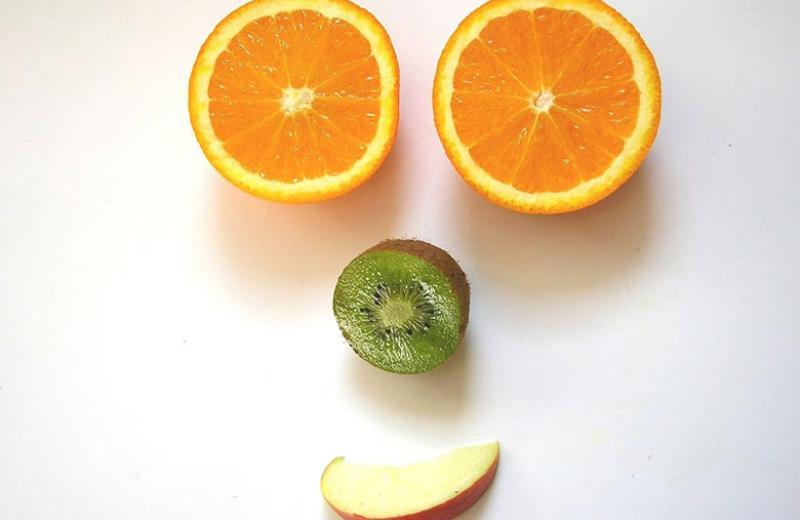 Fruit being used to make a face.