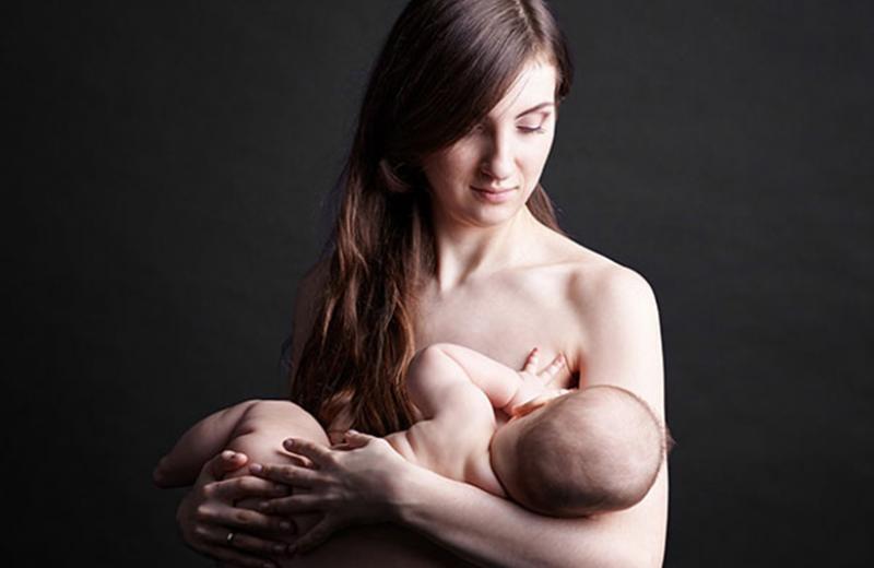 Mother holding a breastfeeding baby.