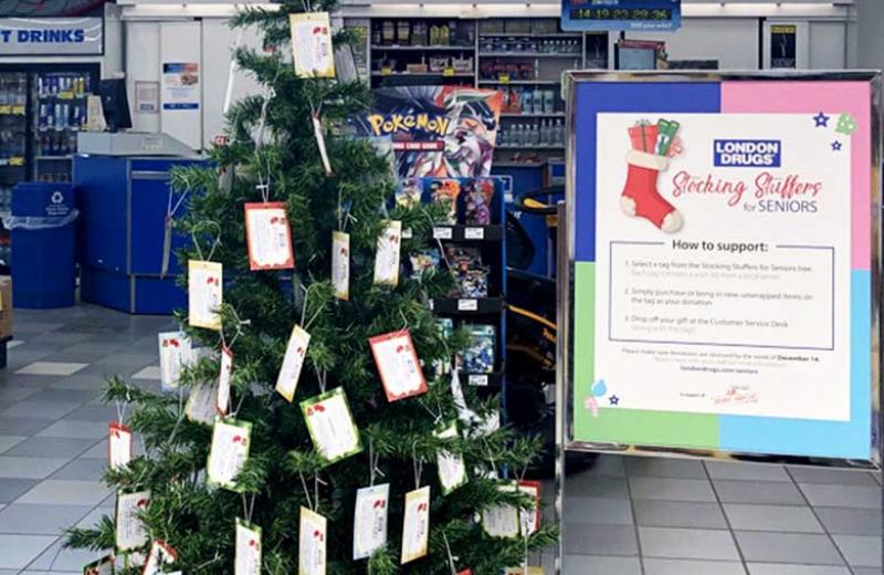 Christmas tree in the Prince George London Drugs store is decorated with tags containing seniors' gift wishes.