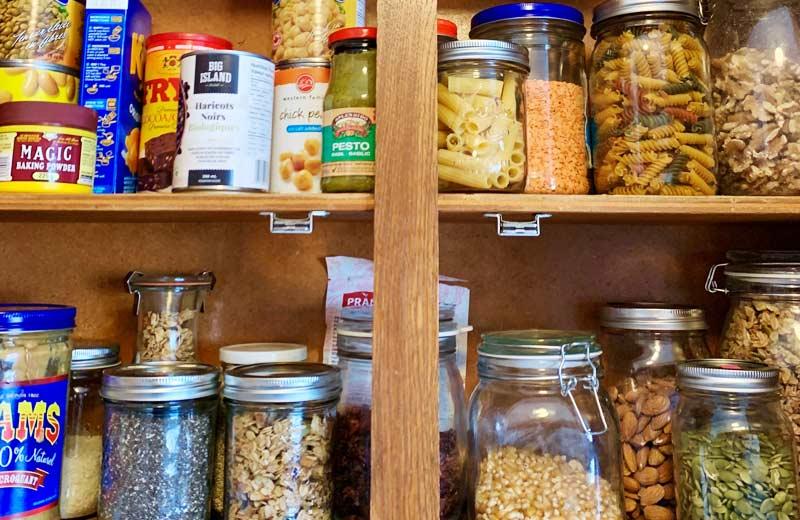 A stocked pantry, full of canned and tried items.