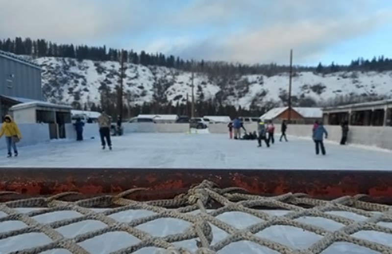 People skating on an outdoor ice rink.