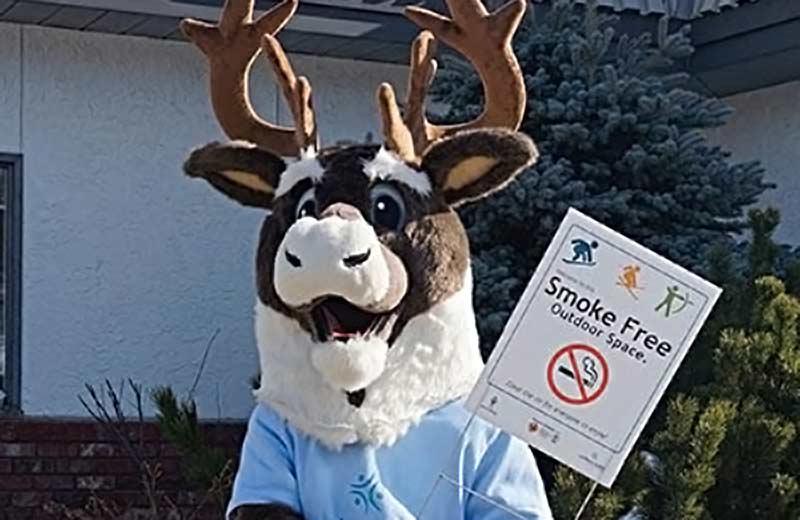 Mascot with smoke-free spaces sign
