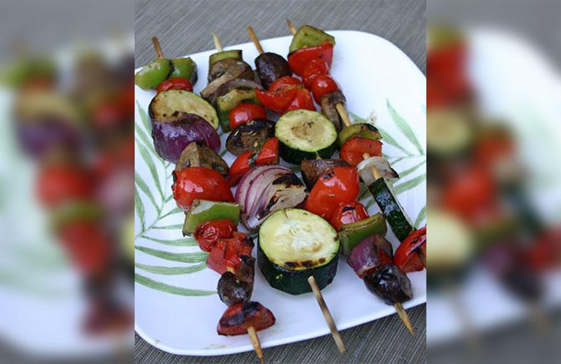 Grilled vegetable skewers with peppers, potatoes, cherry tomatoes, and zucchini