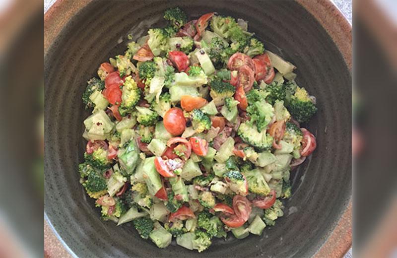 Bowl with broccoli salad and tomatoes