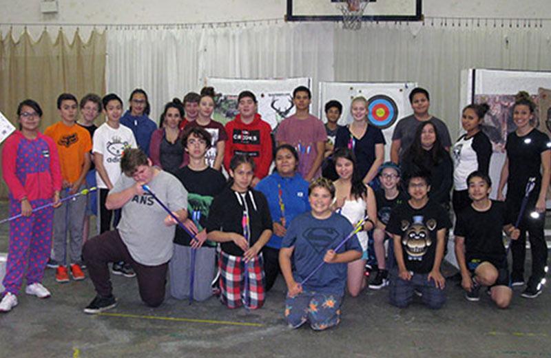Group of young people with archery equipment