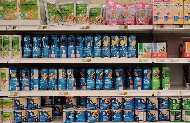 Rows of baby food on the shelf at a store.
