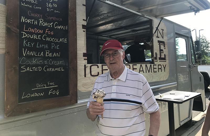 Man with ice cream cone wearing hat