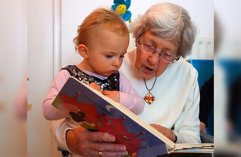 Grandmother reading to grandchild