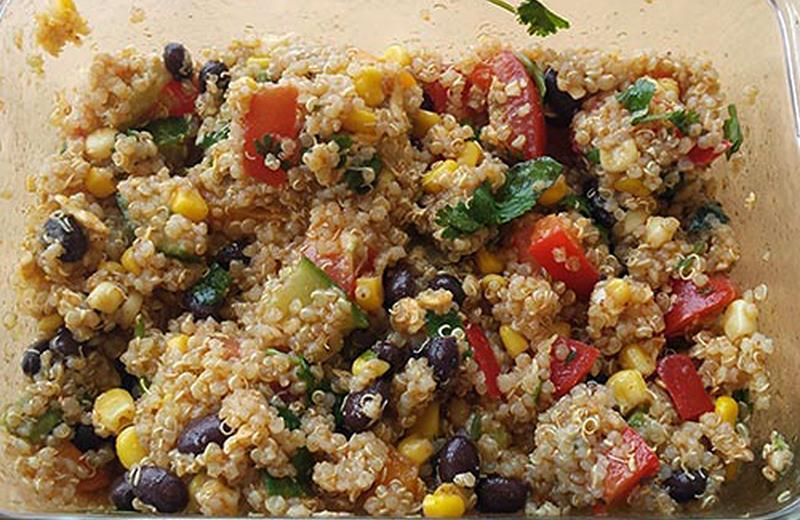 Quinoa salad with vegetables in a glass pan