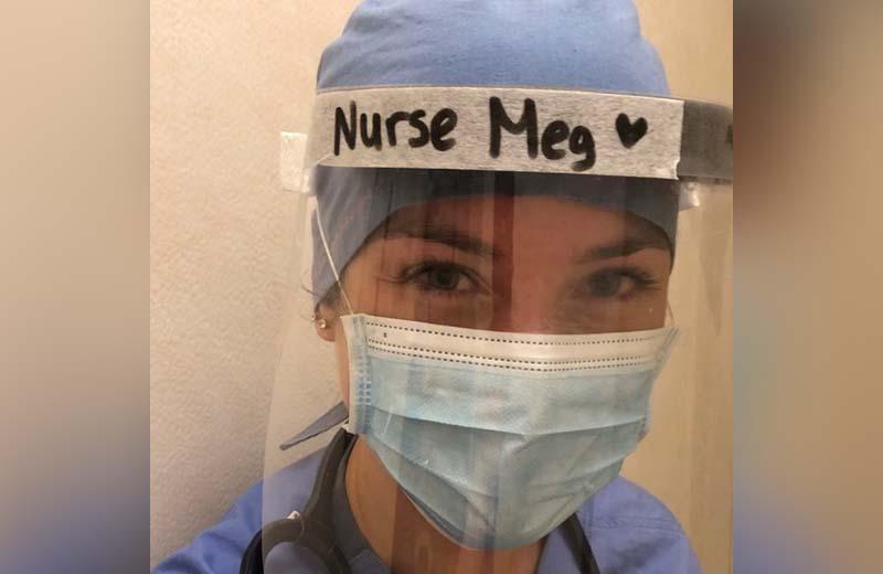 a nurse wearing a face shield and mask. On top of her shield is says "nurse meg"
