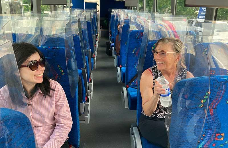 Two women sit on the Northern Health Connections bus
