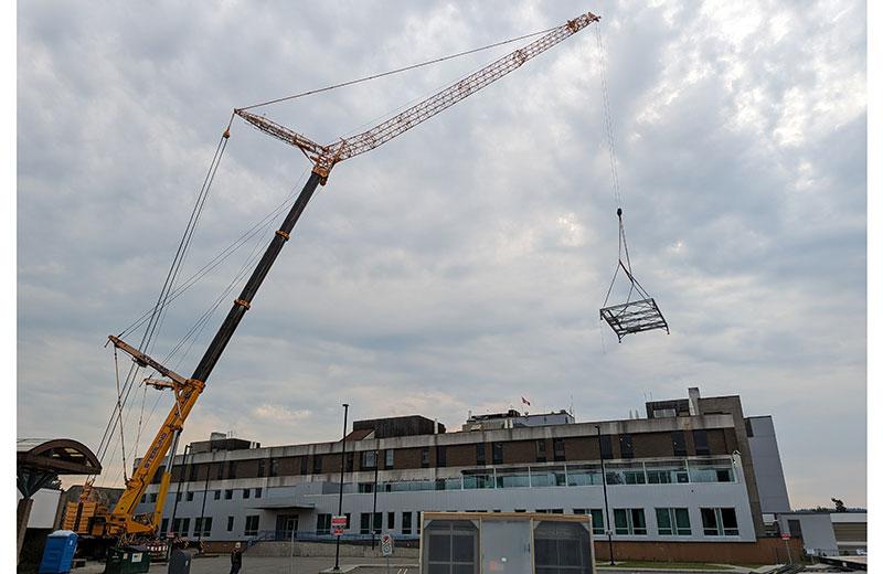 Large construction crane in front of a hospital facility. 