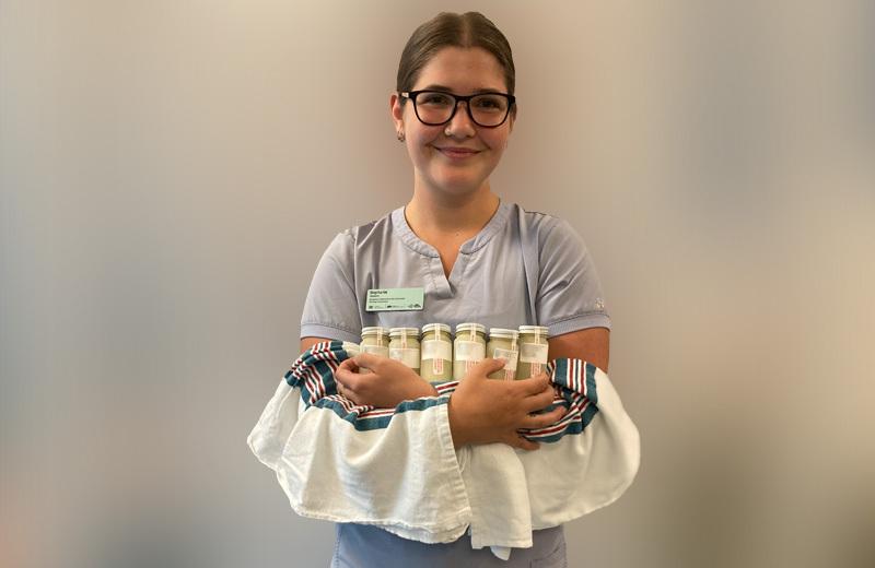 Nurse holds bottles of donated milk