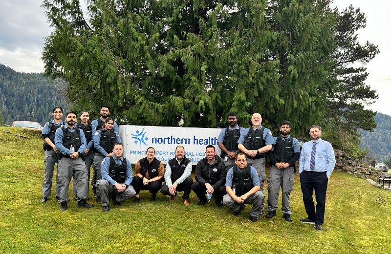 Relational Security team posing in front of the Prince Rupert Hospital sign. 
