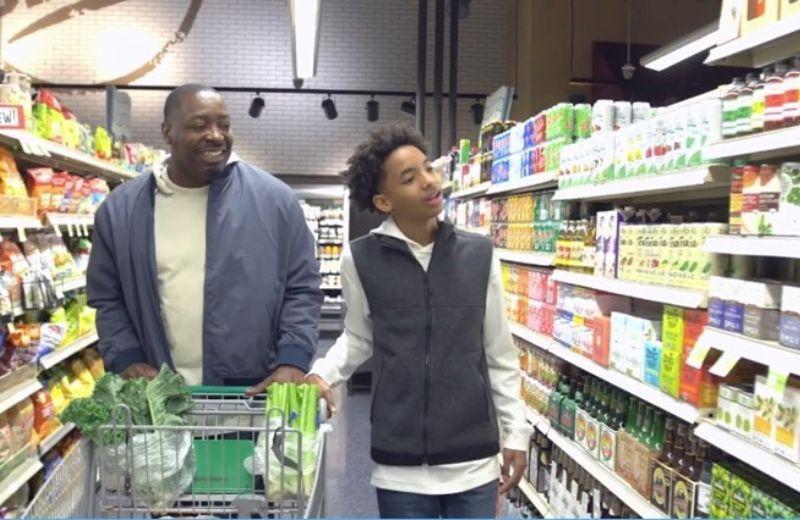 A father and teen son walk the energy drink isle at the grocery store