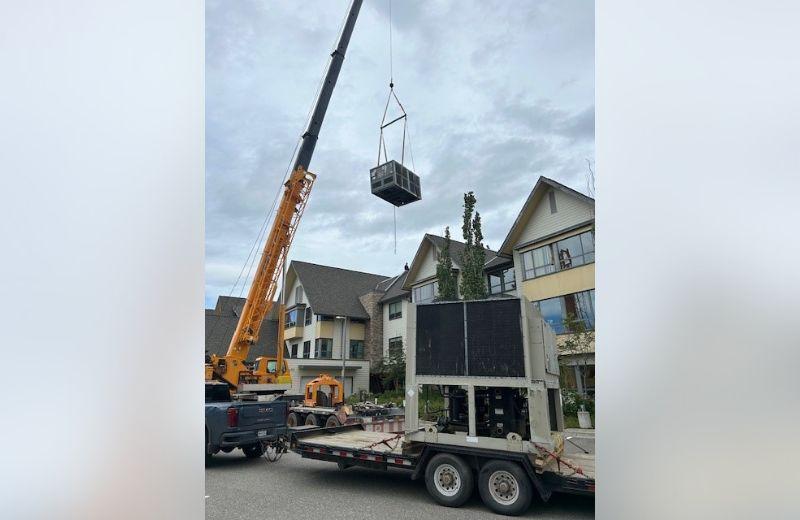 A crane moving the new ciller ventilation system into place. 