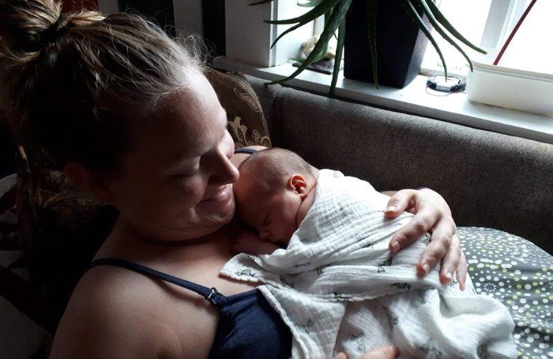 Emma holding Soren on her chest at two days old