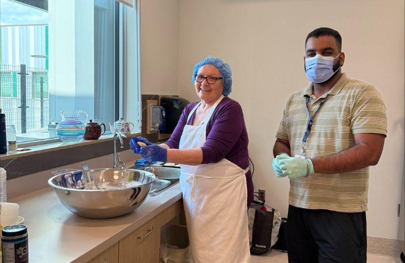 Indigenous Care Team member, Angie Prince, and Activity Worker, Simar Kalra, making Bannock at Nats’oojeh Hospital and Health Centre in Fort St. James.