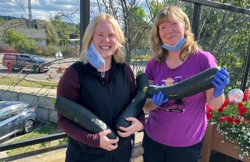NH staff holding zucchinis