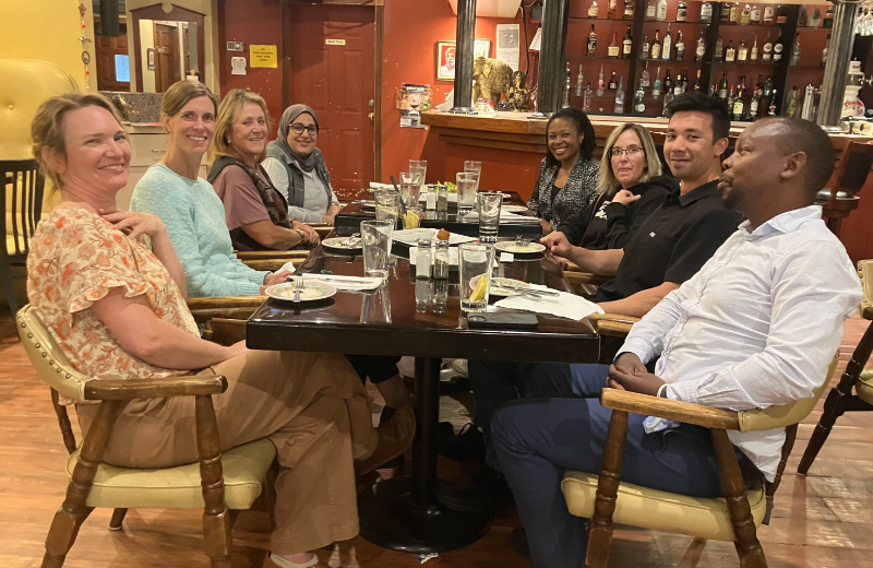 Group of medical providers sit around a table
