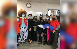 a group of health care workers dressed up in various costumes for halloween