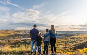 Family stands on edge of valley