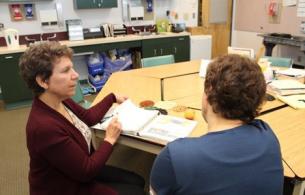 Dietitian sits and shows client resources.