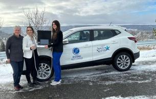 NH staff standing next to their vehicle posing with the mobile ultrasound machine