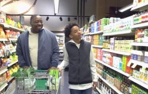 A father and teen son walk the energy drink isle at the grocery store