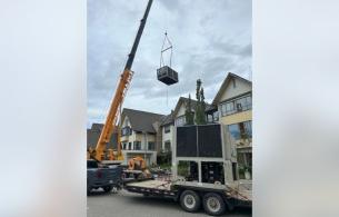 A crane moving the new ciller ventilation system into place. 