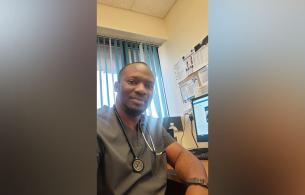 Man in scrubs in a medical office.