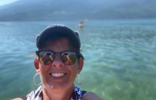 Viva standing in front of  a blue lake