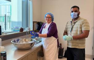 Indigenous Care Team member, Angie Prince, and Activity Worker, Simar Kalra, making Bannock at Nats’oojeh Hospital and Health Centre in Fort St. James.