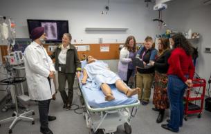 The NCCR team stand around a gurney 