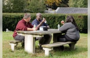 Adults in larger bodies enjoying accessible seating at a picnic table