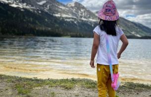 A child llooks out over a lake