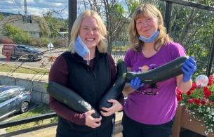 NH staff holding zucchinis
