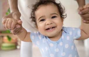 A toddler smiles with 2 new teeth