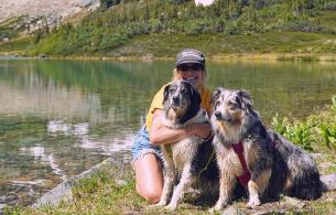Raquel and her dogs posing on a beach