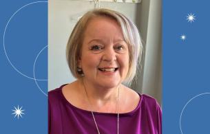 Older woman with short grey blonde hair. 